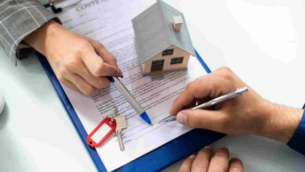 Adding child to home's deed in estate planning. Two people reviewing and signing a deed.