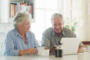 Two seniors reviewing options for Medicare Open Enrollment 2024 and estate planning