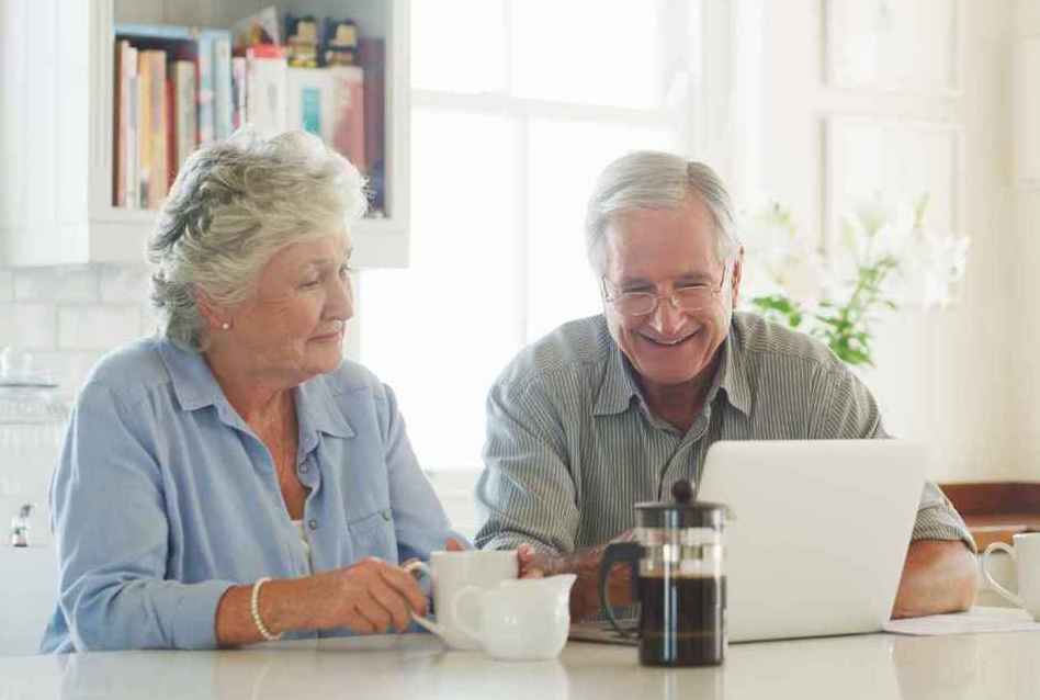 Two seniors reviewing options for Medicare Open Enrollment 2024 and estate planning